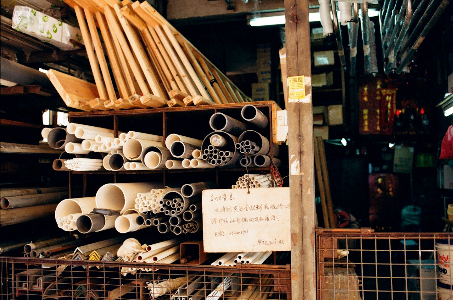 Rauakaupluse riiulid täis metalltorusid ja puitplanke.